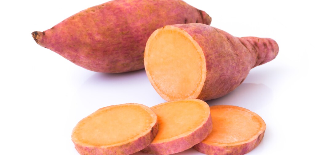 Sweet potato with slices on white background, raw food
