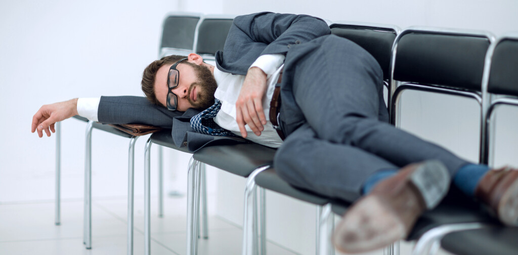 tired businessman lying on chairs and waiting for an interview.photo with copy space