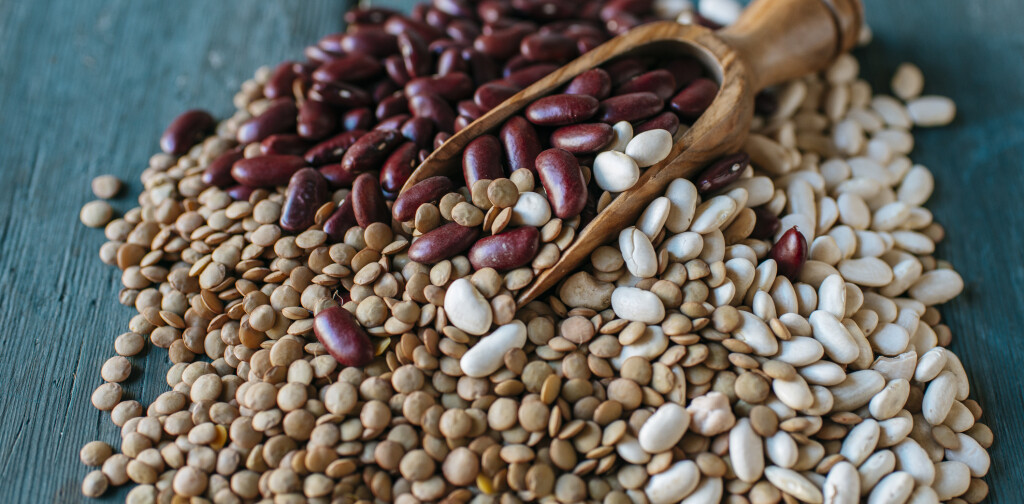 Lentils, red and white beans on blue wood