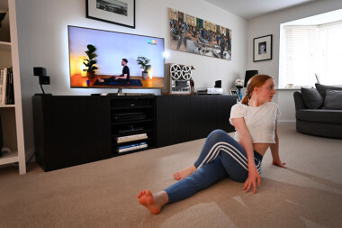 BRIXWORTH, ENGLAND - APRIL 13: Hollie Mason, the photographers daughter, partakes in a live virtual yoga class hosted by Nick Higgins on April 13, 2020 in Brixworth, England. On Monday April 13 at 10AM GMT Nick led a live virtual yoga class which he and Co-Founder Max Henderson hope to be the worlds largest yoga class. Their aim is to raise £125,000 for the NHS to support staff and key workers who are on the front line during the Covid-19 pandemic.(Photo by Clive Mason/Getty Images)
