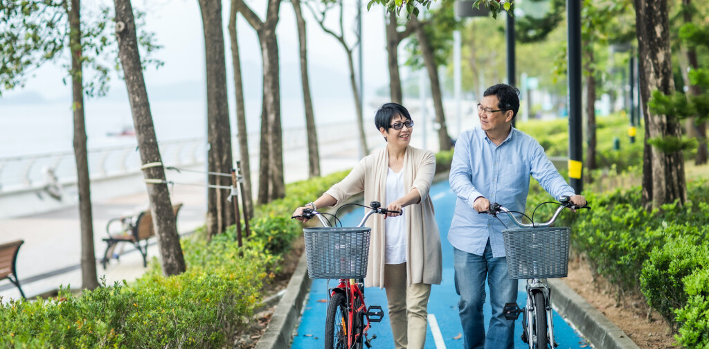 Senior couple with bicycles in the park.