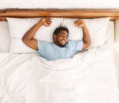 Sweet dreams. Peaceful black guy enjoying nap, resting in bed, top view with empty space